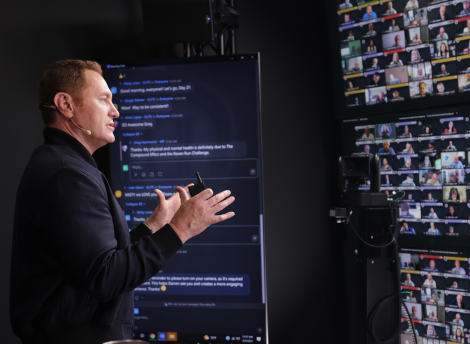 Darren gesticulating in front of screens during a filming of Business Master Class